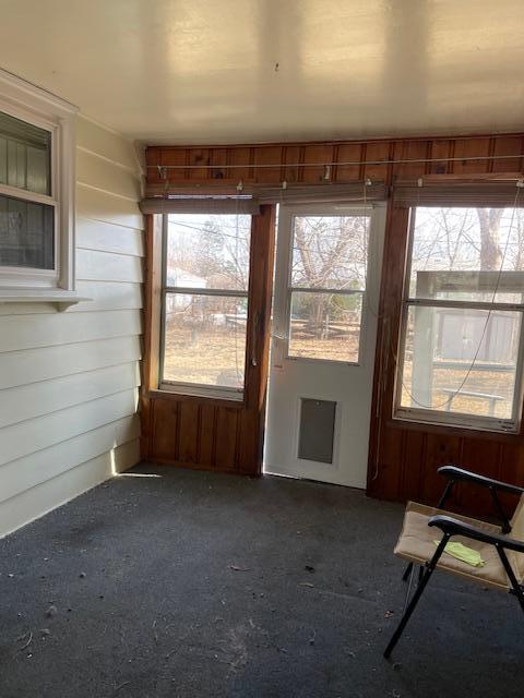 unfurnished sunroom featuring plenty of natural light