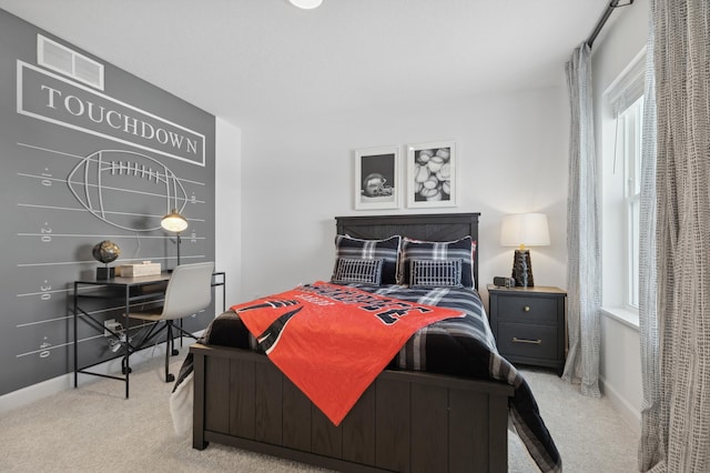 bedroom featuring light carpet, baseboards, multiple windows, and visible vents