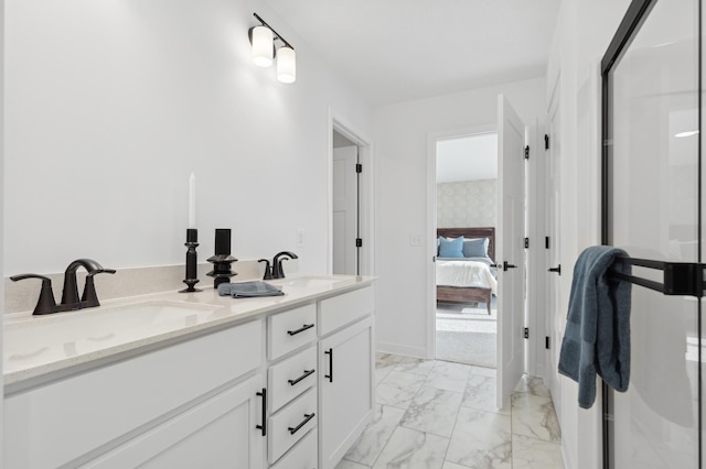 ensuite bathroom featuring marble finish floor, a sink, ensuite bath, and double vanity