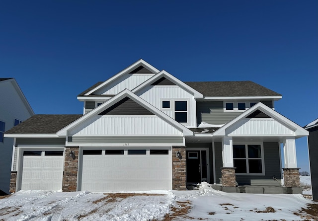 craftsman inspired home featuring a garage, a shingled roof, board and batten siding, and covered porch