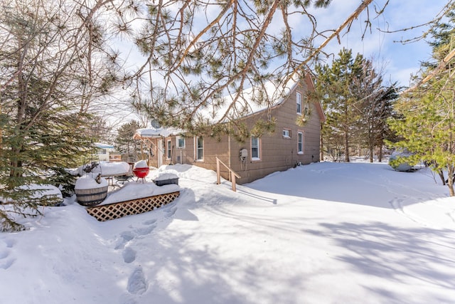 view of snow covered back of property