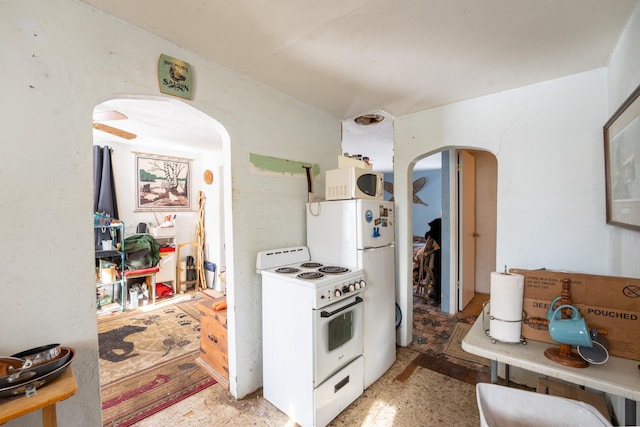 kitchen with white appliances and arched walkways