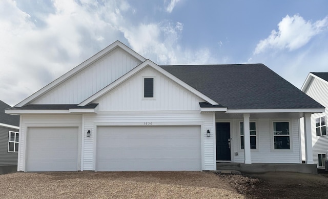 view of front of property featuring a porch, driveway, a garage, and board and batten siding