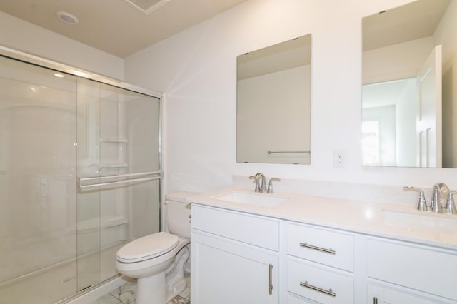 bathroom featuring marble finish floor, a stall shower, toilet, and a sink