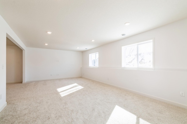 carpeted spare room with recessed lighting and baseboards