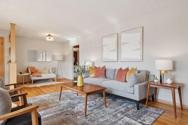 living area featuring baseboards and wood finished floors