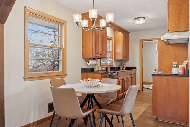 dining area with a notable chandelier, baseboards, and a wealth of natural light