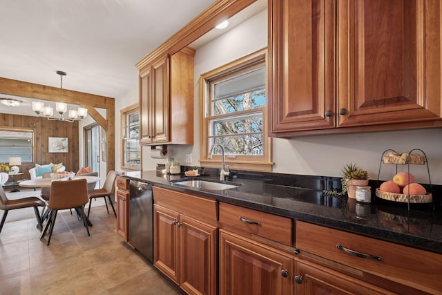 kitchen featuring brown cabinetry, a notable chandelier, black dishwasher, and a sink