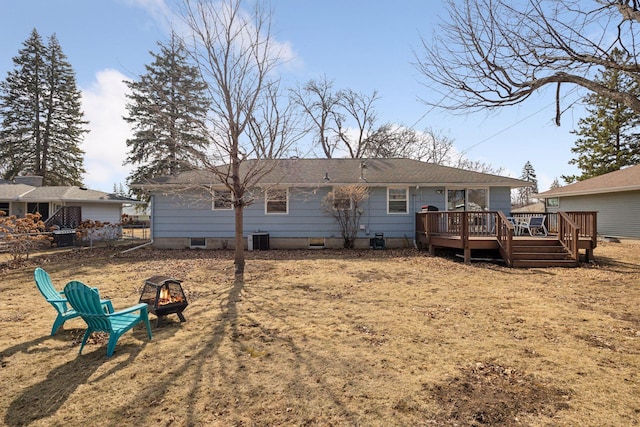 rear view of property featuring fence, a wooden deck, an outdoor fire pit, central AC, and crawl space