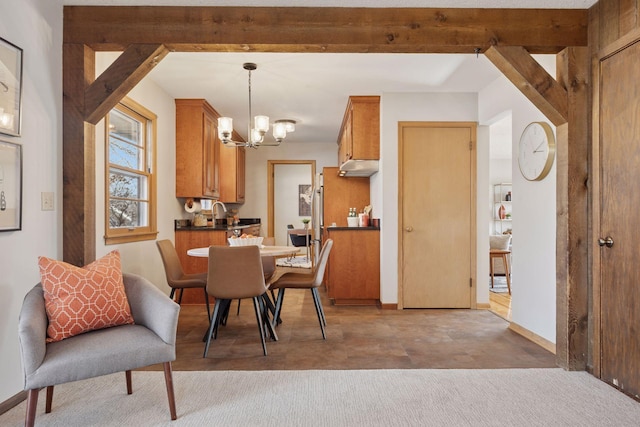 dining space featuring beam ceiling, baseboards, and an inviting chandelier