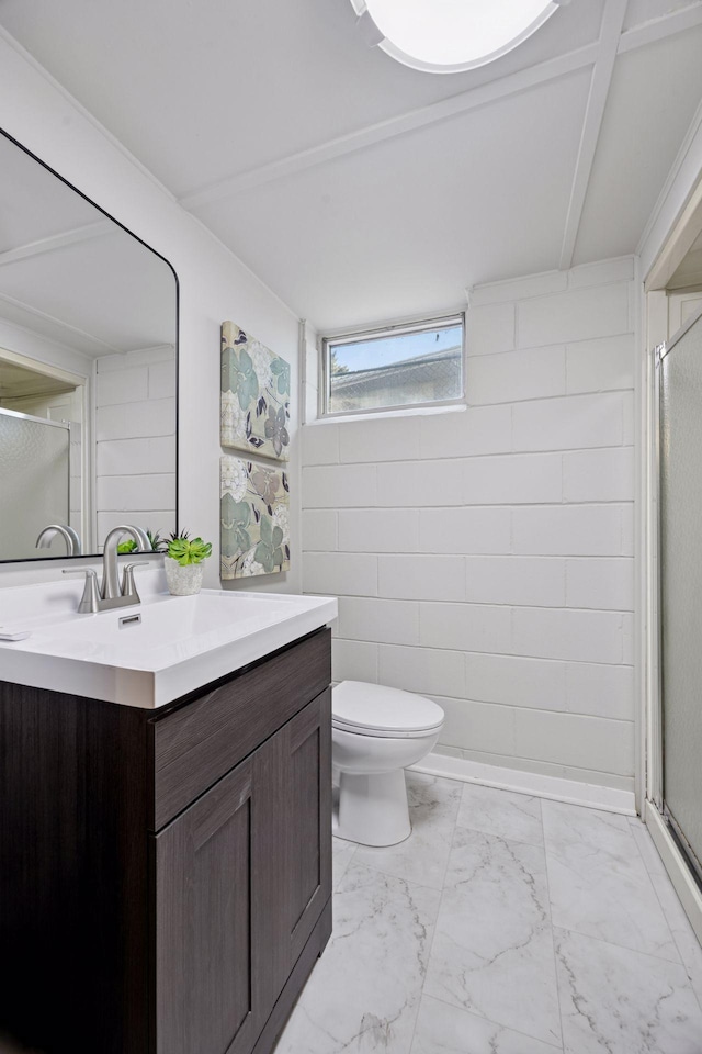 bathroom featuring marble finish floor, a stall shower, vanity, and toilet