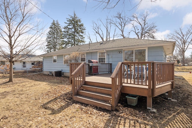 rear view of house featuring cooling unit and a wooden deck