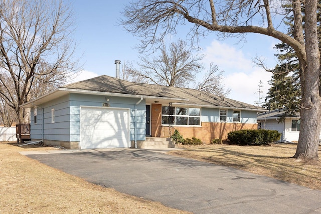 ranch-style home with an attached garage and driveway