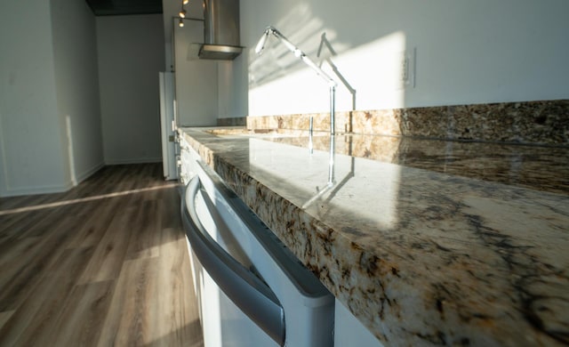 kitchen featuring dark wood finished floors and stainless steel dishwasher