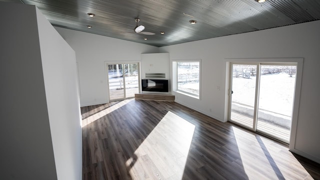 unfurnished living room with baseboards, a glass covered fireplace, lofted ceiling, wood ceiling, and wood finished floors