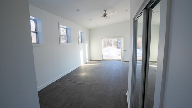 unfurnished room with dark wood-type flooring, lofted ceiling, ceiling fan, and baseboards