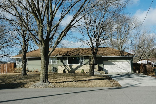 ranch-style home with a garage, concrete driveway, and fence