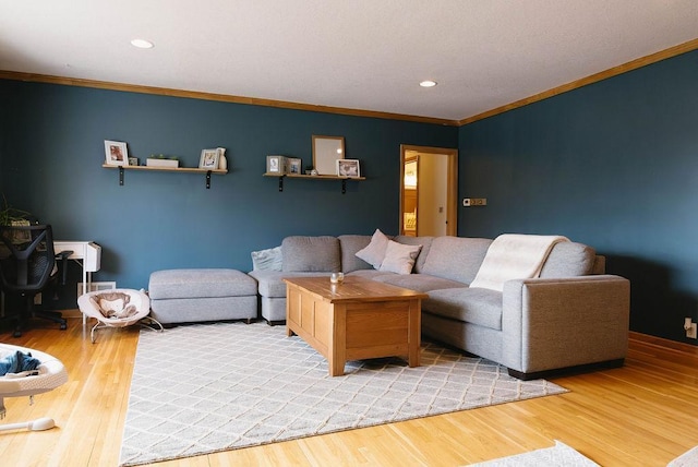 living room with light wood-style floors, recessed lighting, and crown molding