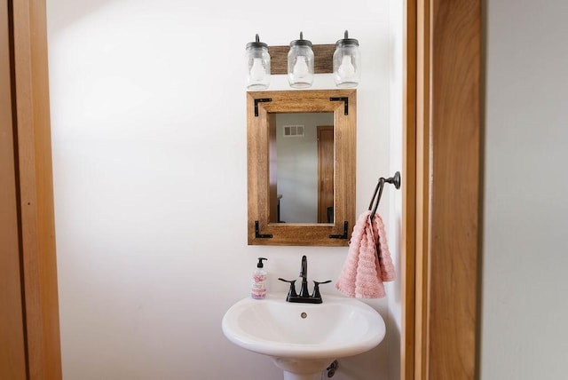 bathroom featuring visible vents and a sink