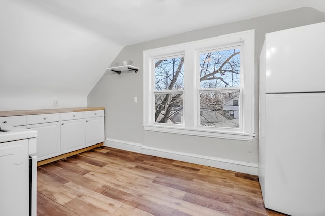 bonus room with light wood-type flooring, lofted ceiling, and baseboards