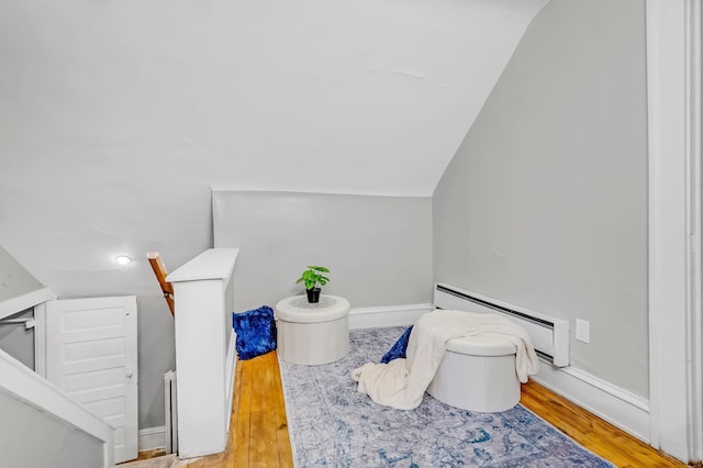 bathroom featuring lofted ceiling, baseboards, baseboard heating, and wood finished floors