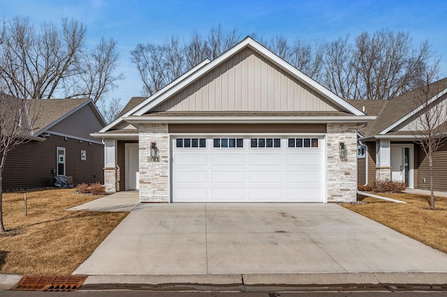 view of front facade featuring stone siding, driveway, a garage, and board and batten siding