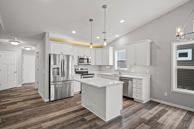 kitchen featuring lofted ceiling, white cabinets, dark wood-style floors, and stainless steel appliances