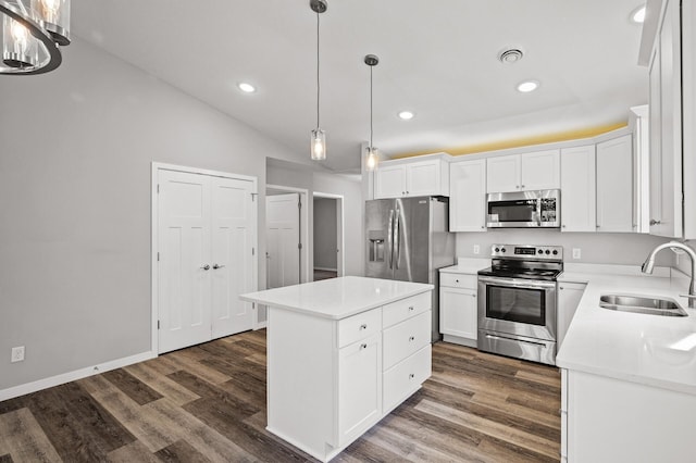 kitchen featuring a sink, a kitchen island, appliances with stainless steel finishes, and dark wood-style floors