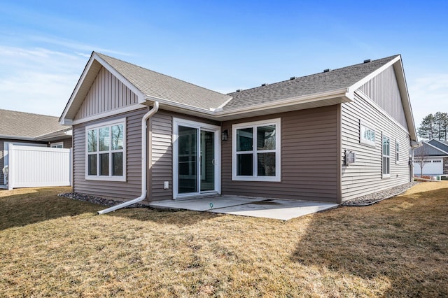 back of house with a patio, fence, roof with shingles, a lawn, and board and batten siding