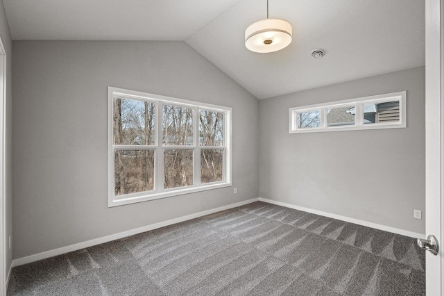 spare room featuring carpet flooring, baseboards, visible vents, and vaulted ceiling