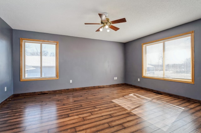 unfurnished room with a ceiling fan, a textured ceiling, and wood finished floors