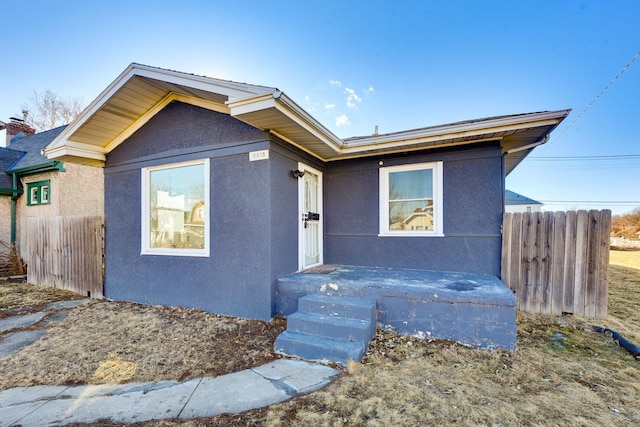 view of front of home featuring fence and stucco siding