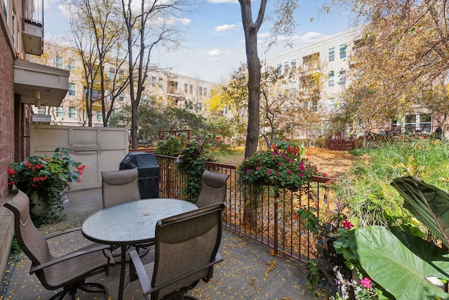 view of patio with outdoor dining space and fence