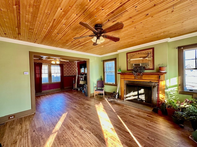 unfurnished living room featuring a fireplace with flush hearth, ornamental molding, wood ceiling, wood finished floors, and baseboards