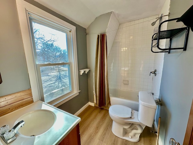 bathroom with shower / tub combo, baseboards, toilet, wood finished floors, and vanity