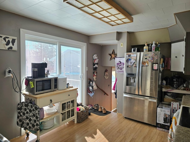 kitchen featuring light wood-style floors, appliances with stainless steel finishes, and white cabinets