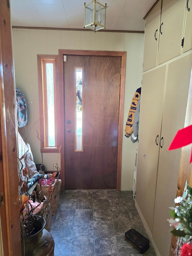 entryway with stone finish flooring and a decorative wall