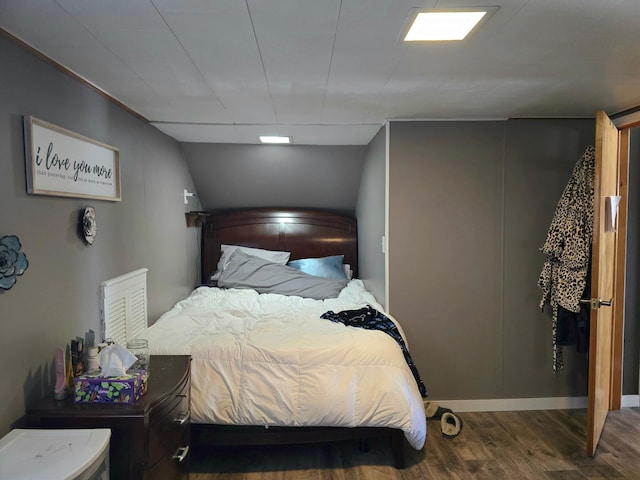 bedroom featuring wood finished floors and baseboards