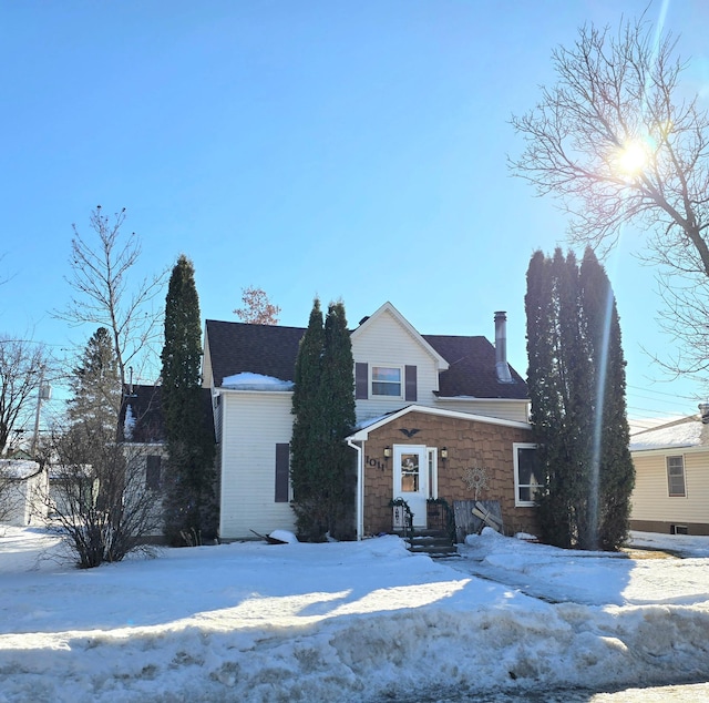 view of front of house featuring a chimney