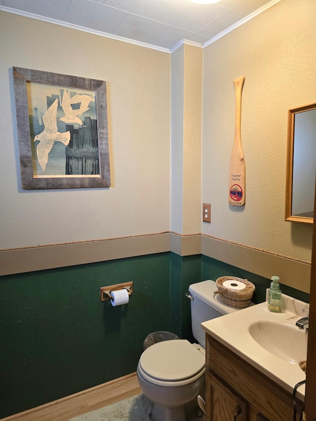 bathroom featuring crown molding, toilet, and vanity