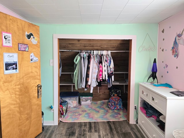 bedroom featuring wood finished floors and a closet