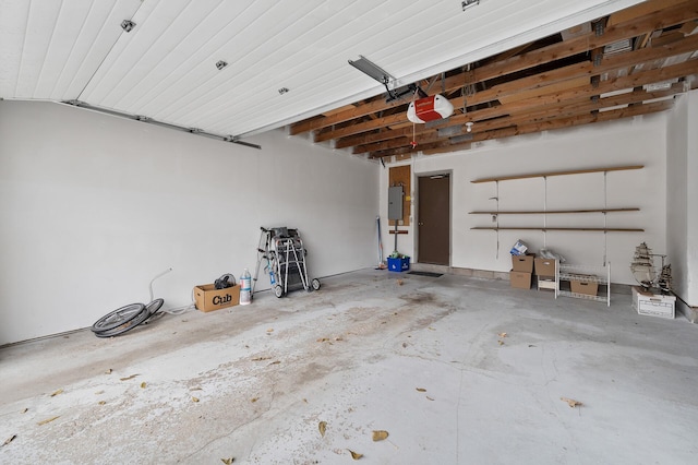 garage with electric panel and a garage door opener