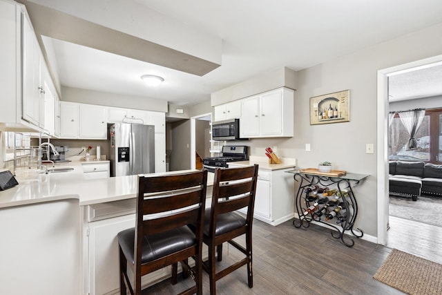 kitchen with light countertops, appliances with stainless steel finishes, and white cabinets