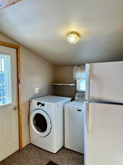 washroom featuring laundry area and washing machine and clothes dryer