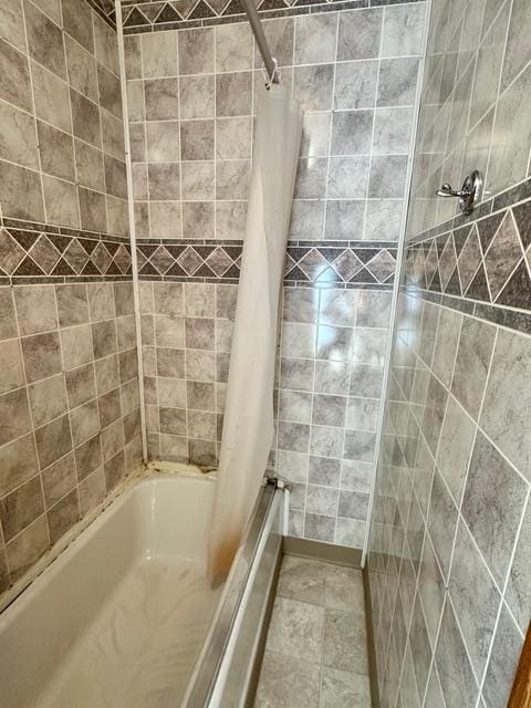 full bathroom with shower / tub combo and tile patterned floors