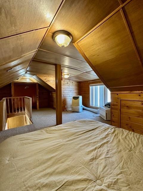 unfurnished bedroom with carpet floors, lofted ceiling, wooden ceiling, and wood walls