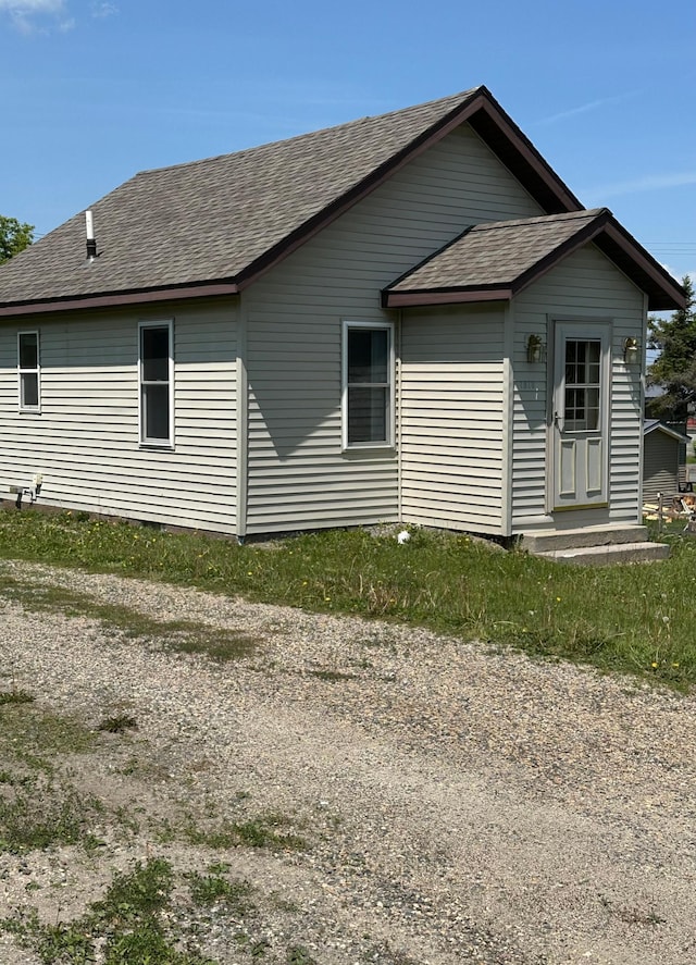 1810 3rd Ave E, International Falls, MN 56649 - view of home's exterior featuring roof with shingles and crawl space