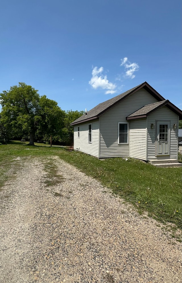 1810 3rd Ave E, International Falls, MN 56649 - view of side of property with a shingled roof and gravel driveway