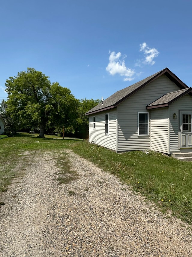 1810 3rd Ave E, International Falls, MN 56649 - view of side of property featuring driveway and a shingled roof