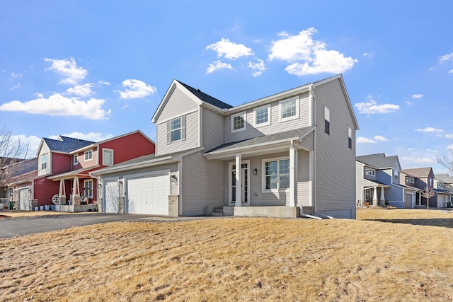 traditional-style home with driveway, a garage, and a residential view